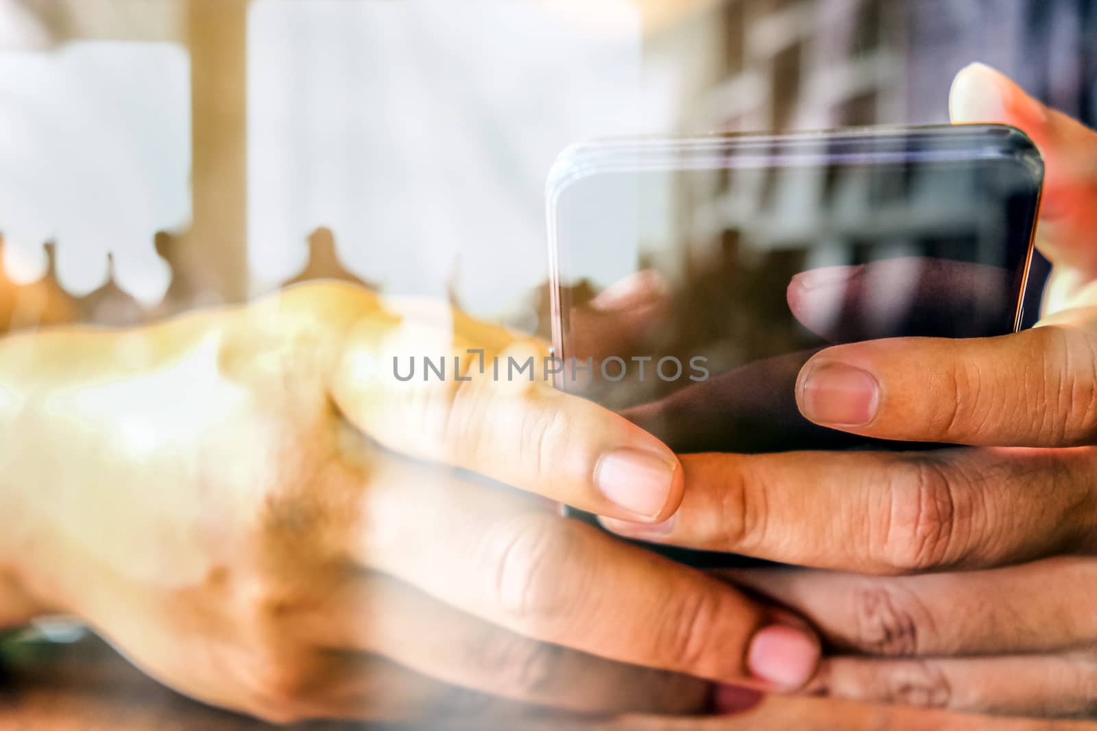 Hands with mobile, double exposure