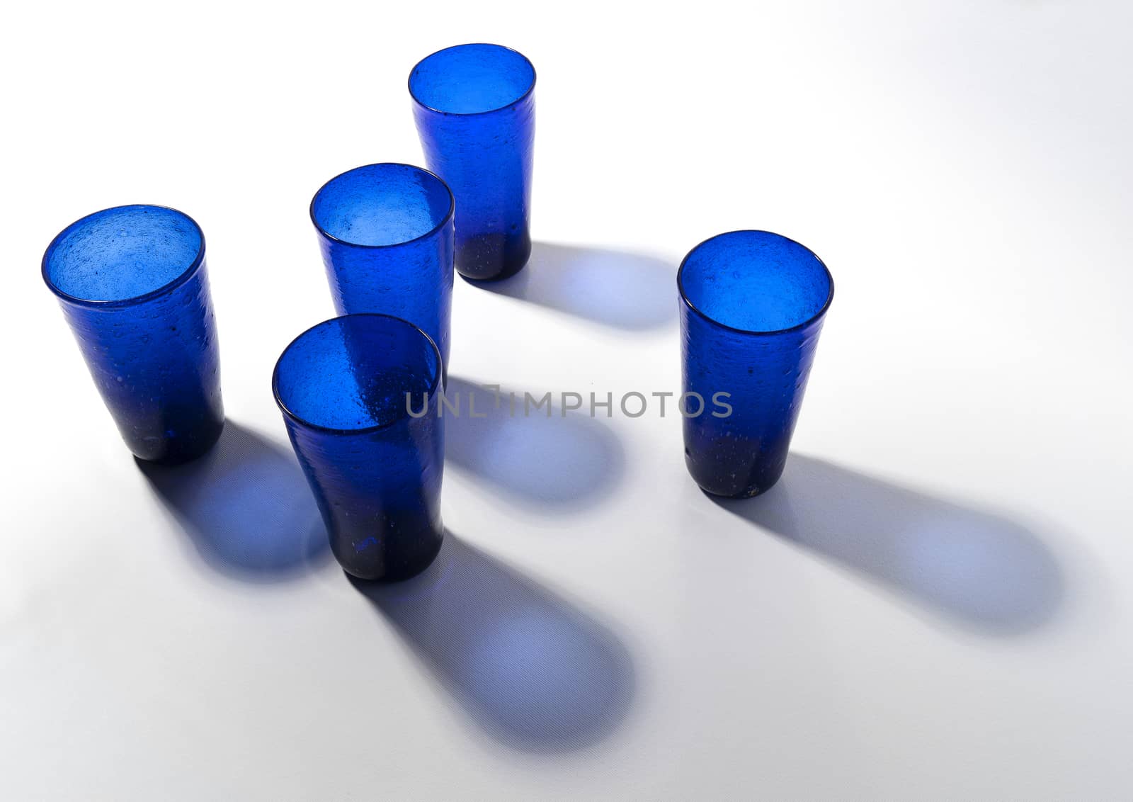 Some blue glasses on a white surface