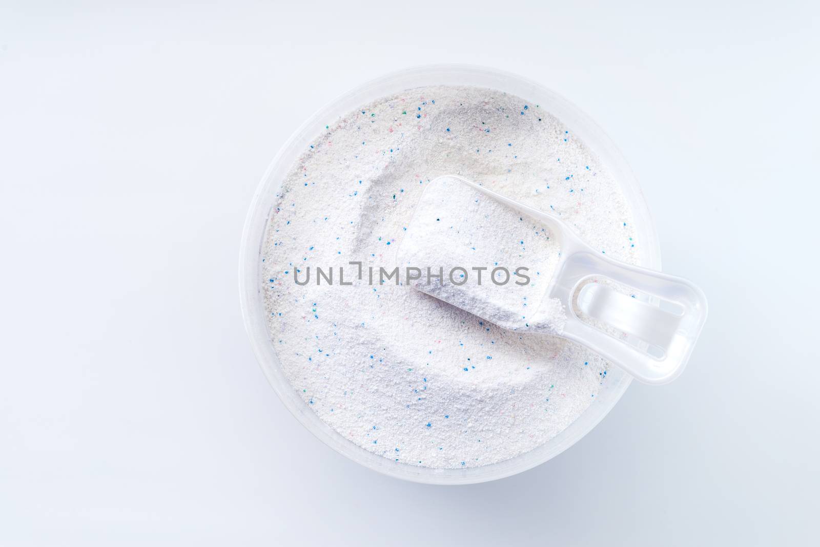 washing powder with measuring cup on a washing powder box isolated on white background