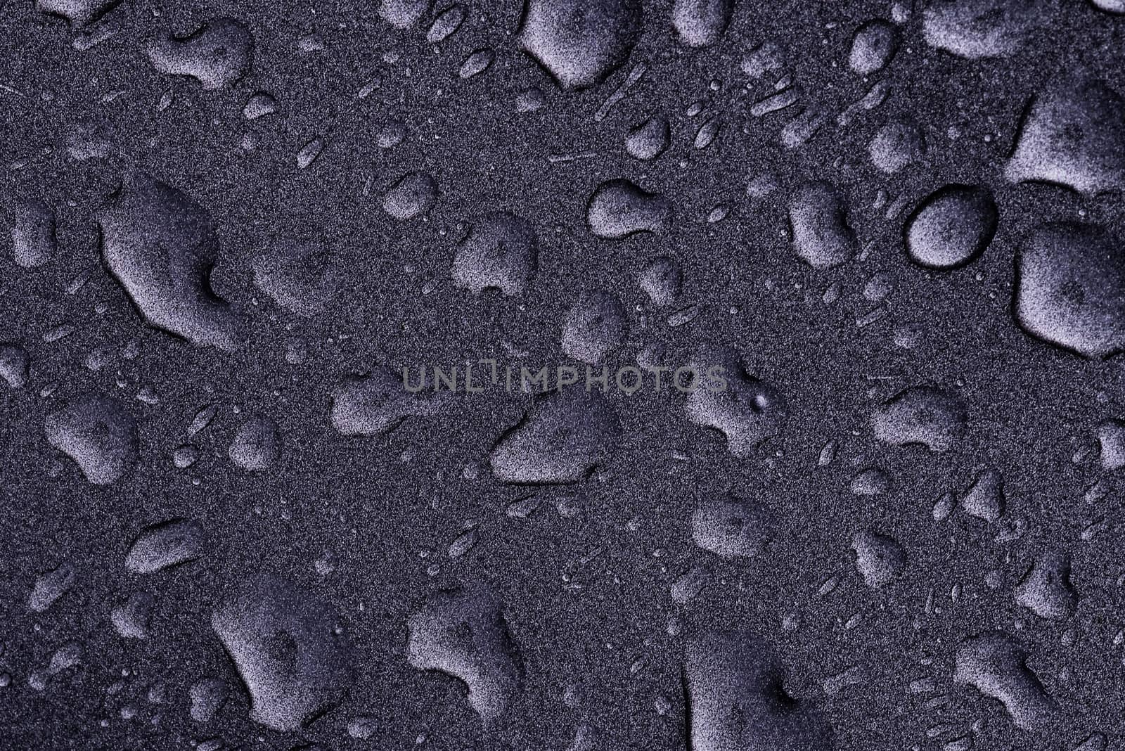 Fresh raw chicken fillet on a wooden cutting board.Water droplets on black background.