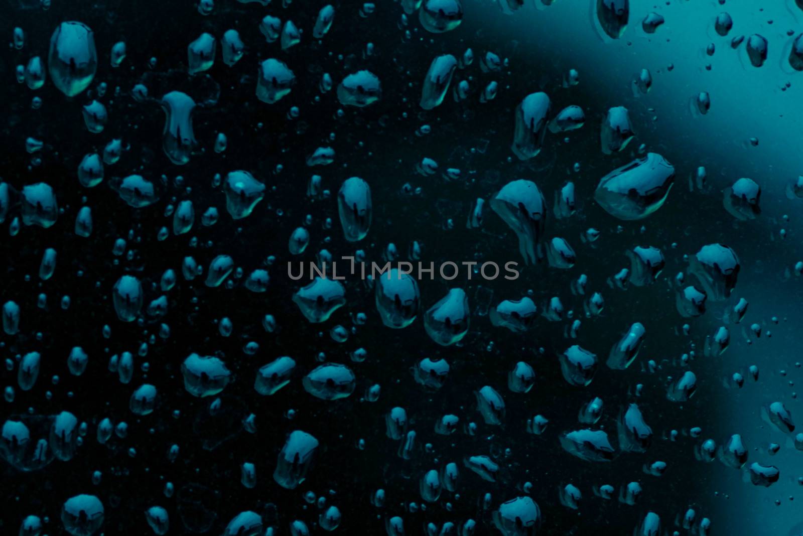 Fresh raw chicken fillet on a wooden cutting board.Water droplets on black background.