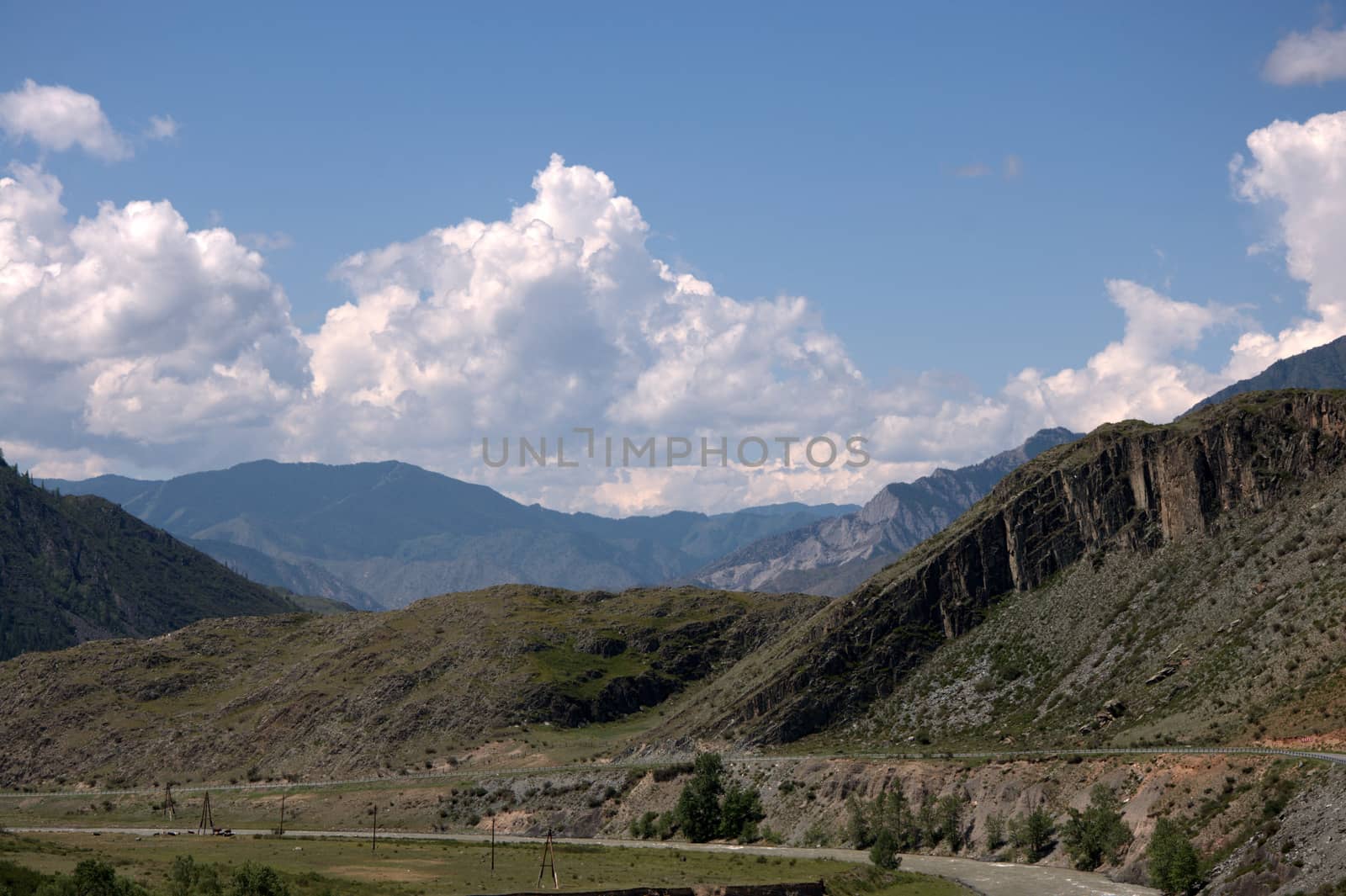 Poor pasture in spring, surrounded by high rocky hills. Altai, Siberia, Russia