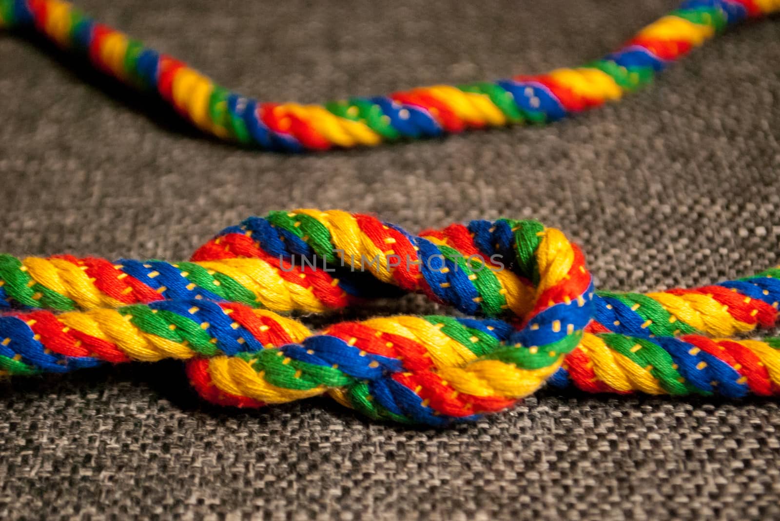 A rainbow colored rope tied into a knot