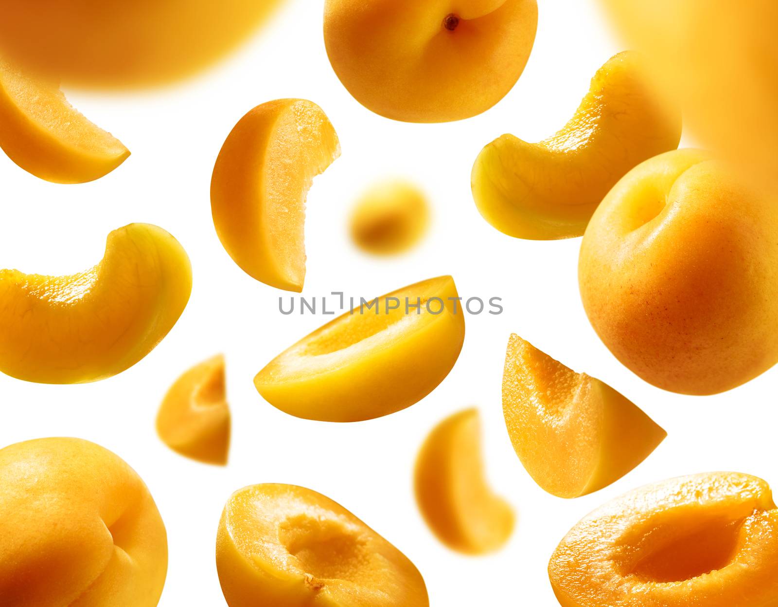 Apricots levitate on a white background. Ripe fruit in flight.