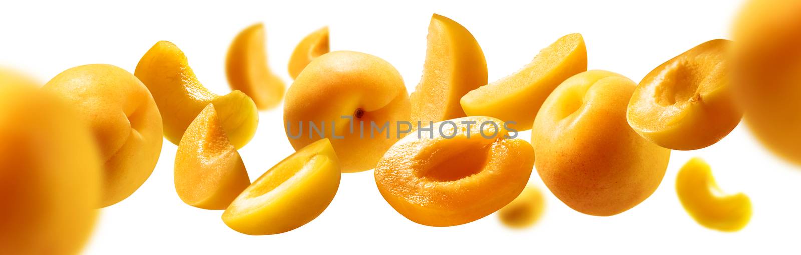 Apricots levitate on a white background. Ripe fruit in flight.