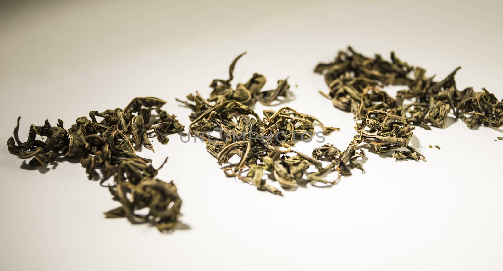 inscription tea from green tea leaves on a white background.