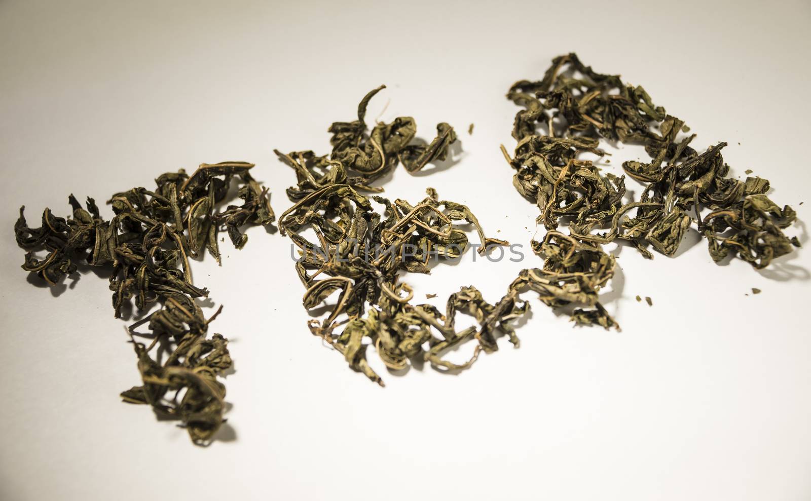 inscription tea from green tea leaves on a white background by butenkow