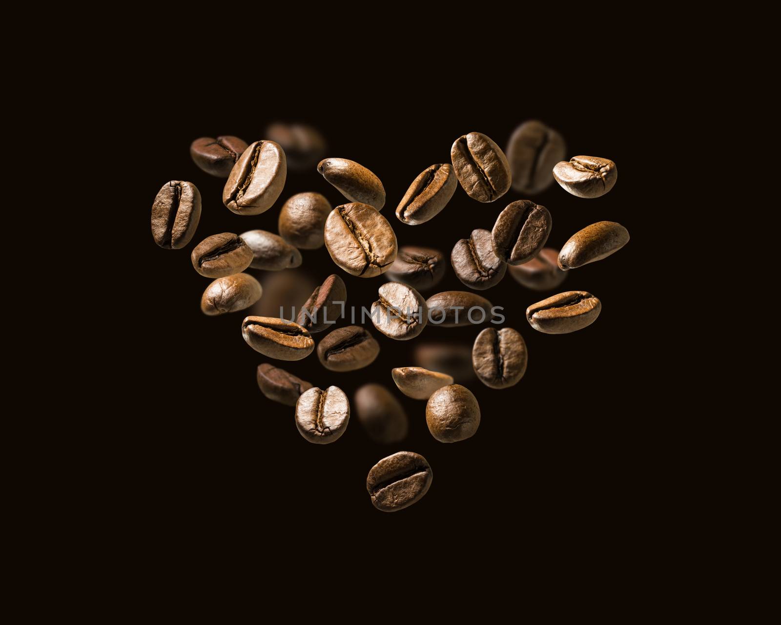 Coffee beans in flight in the shape of a heart.