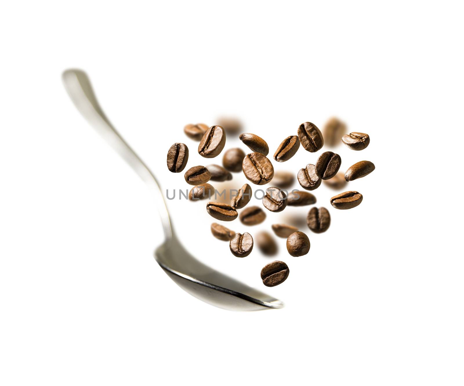 Coffee beans in the shape of a heart and a spoon in flight.