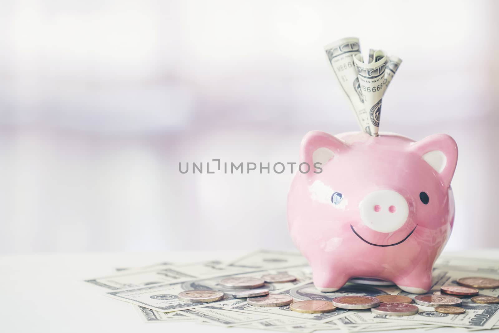 pink color piggy bank on white table by anankkml