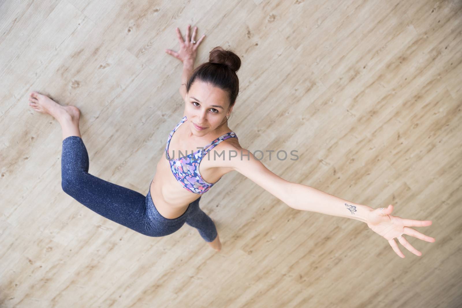 Fit sporty active girl in fashion sportswear doing yoga fitness exercise in yoga studio. Active urban lifestyle.