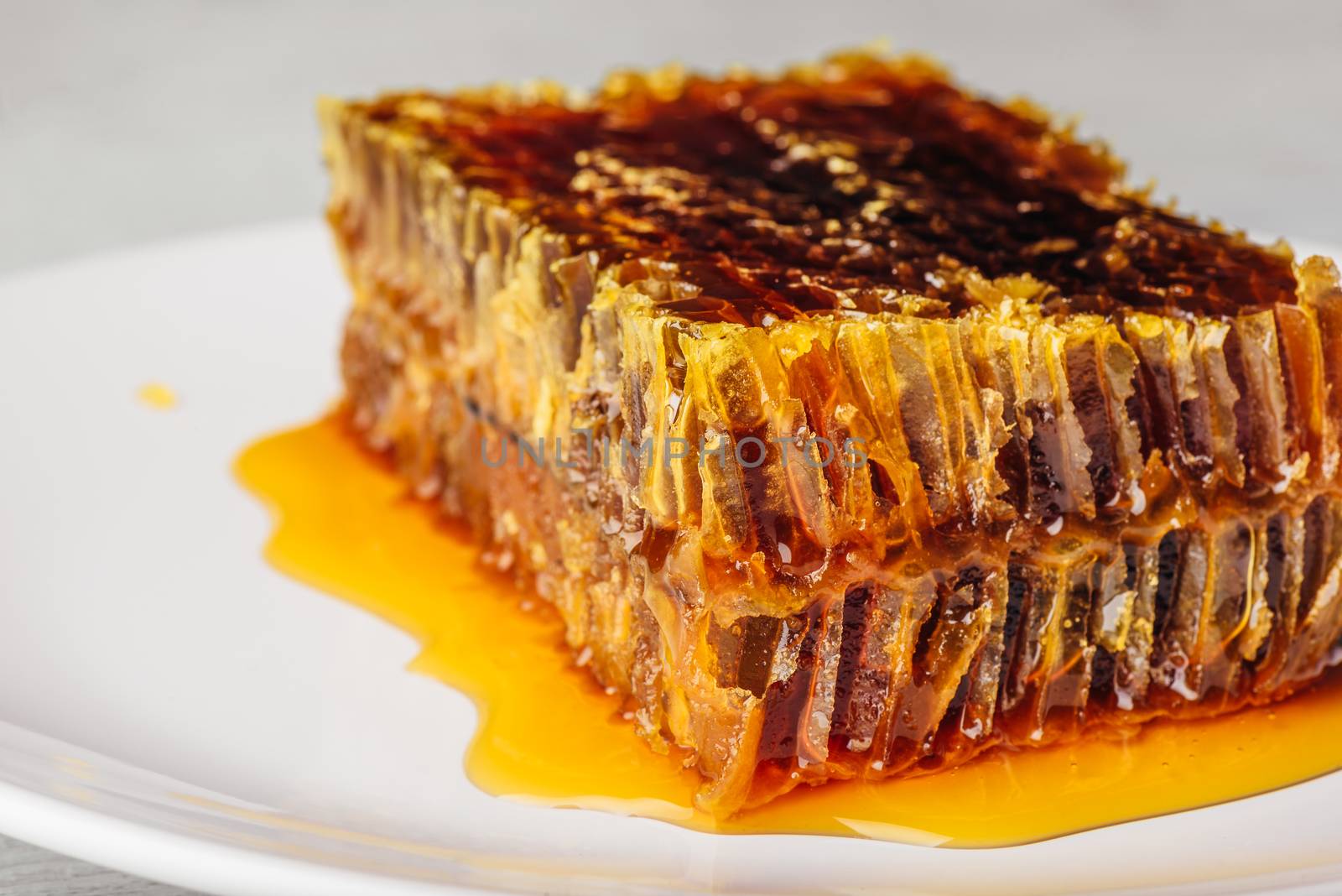 Close-up of delicious honeycomb on light background