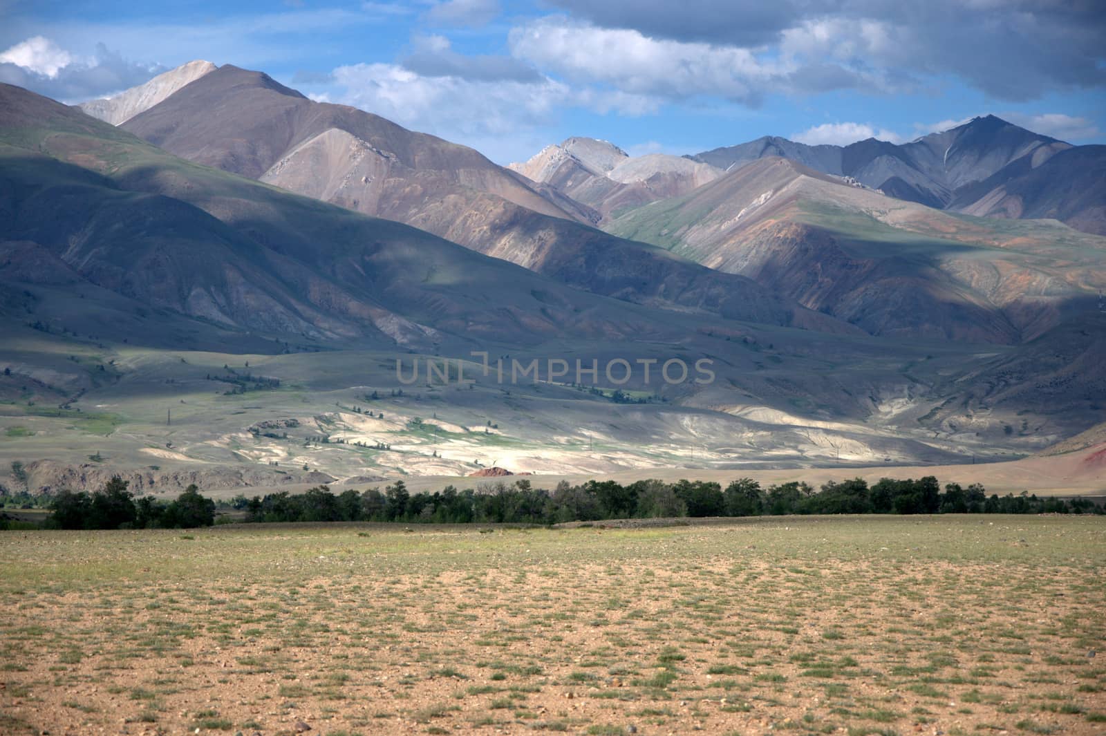 Desert steppe at the foot of the red mountains. The tract Chagan-Uzun, Martian landscapes, Altai, Siberia, Russia.