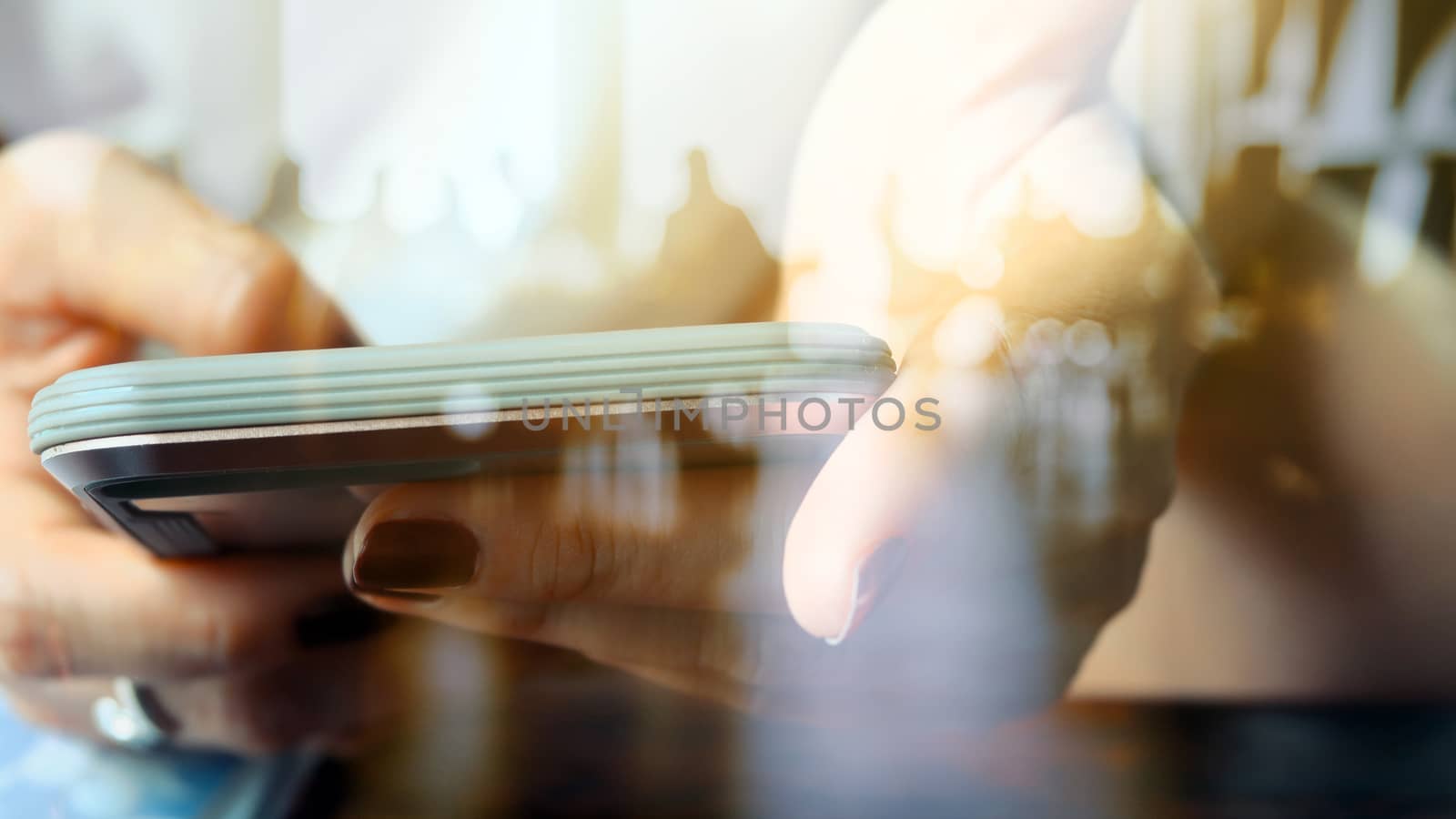 Hands with mobile, double exposure