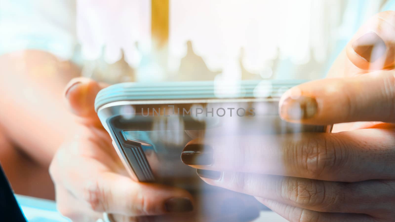 Hands with mobile, double exposure