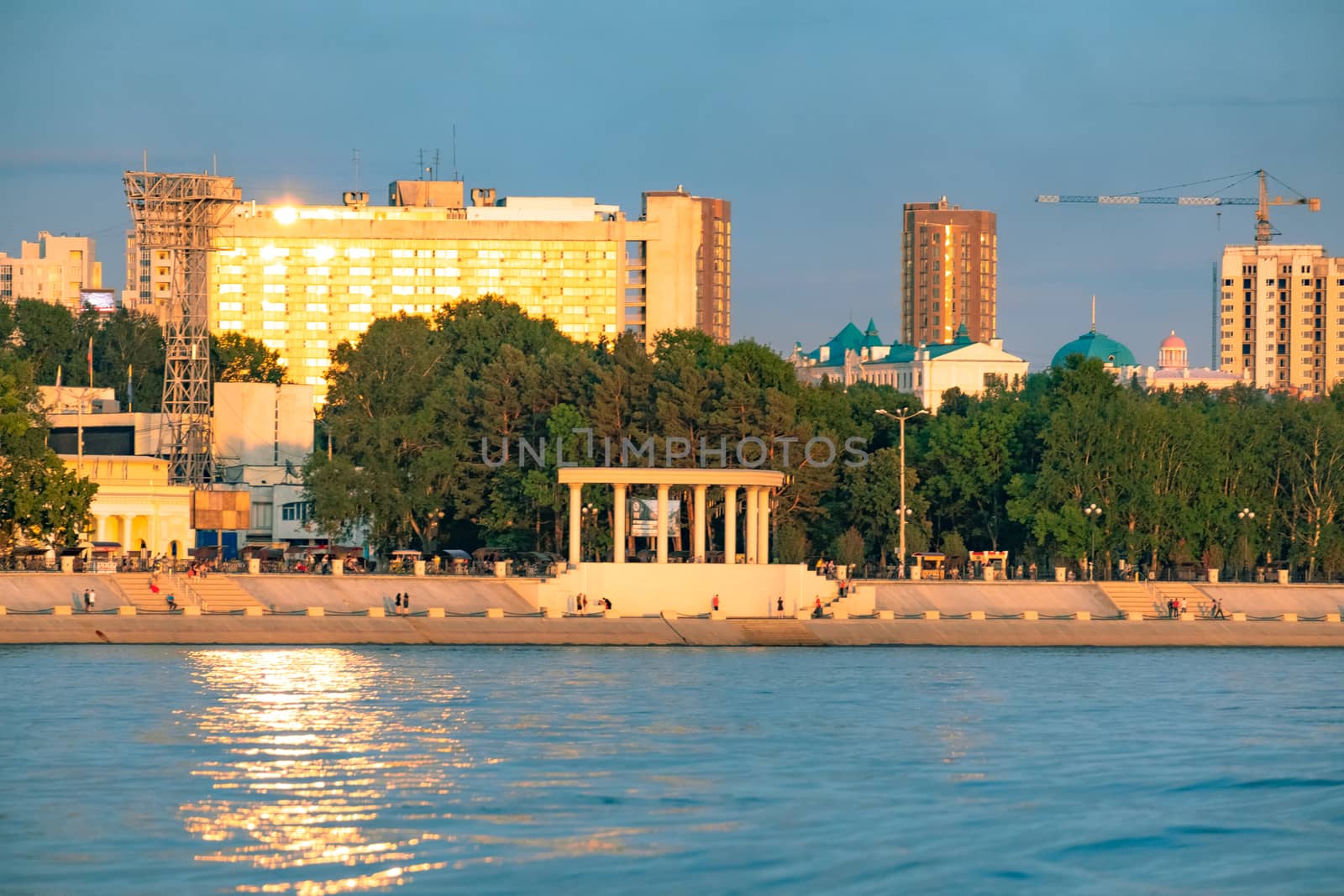 View of the city of Khabarovsk from the Amur river. Urban landscape in the evening at sunset