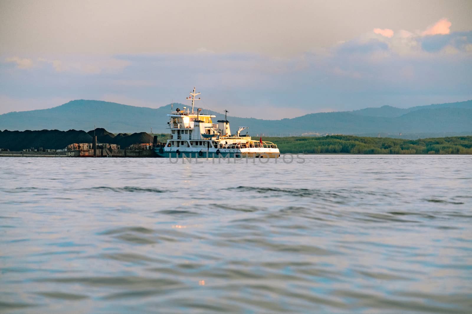 View of the city of Khabarovsk from the Amur river. Urban landscape in the evening at sunset