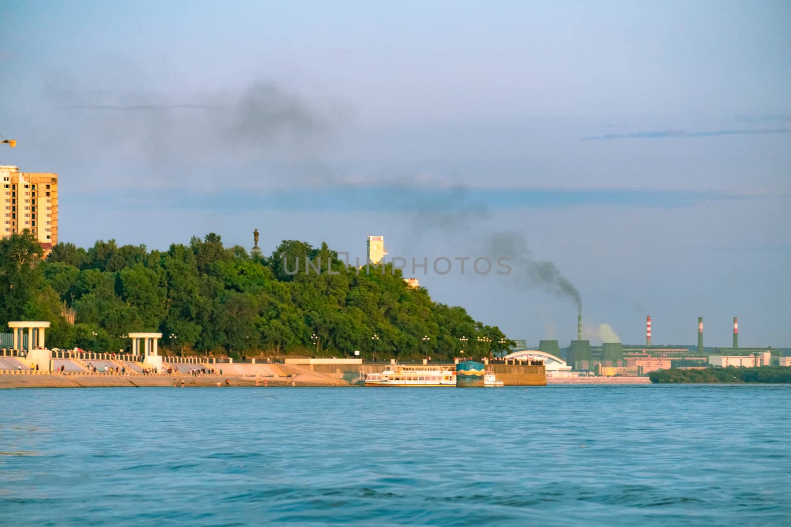 View of the city of Khabarovsk from the Amur river. Urban landscape in the evening at sunset