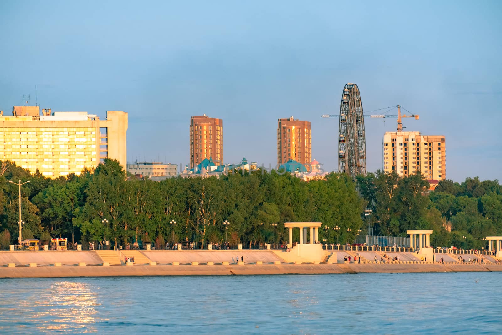 View of the city of Khabarovsk from the Amur river. Urban landscape in the evening at sunset