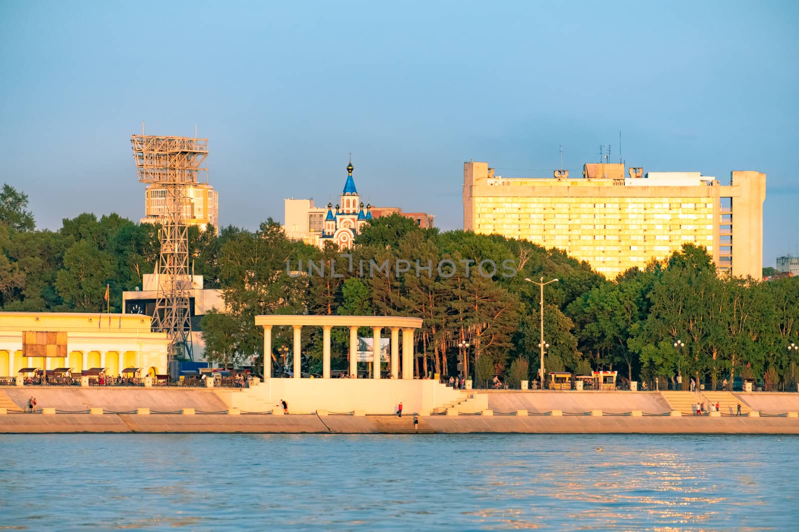 View of the city of Khabarovsk from the Amur river. Urban landscape in the evening at sunset