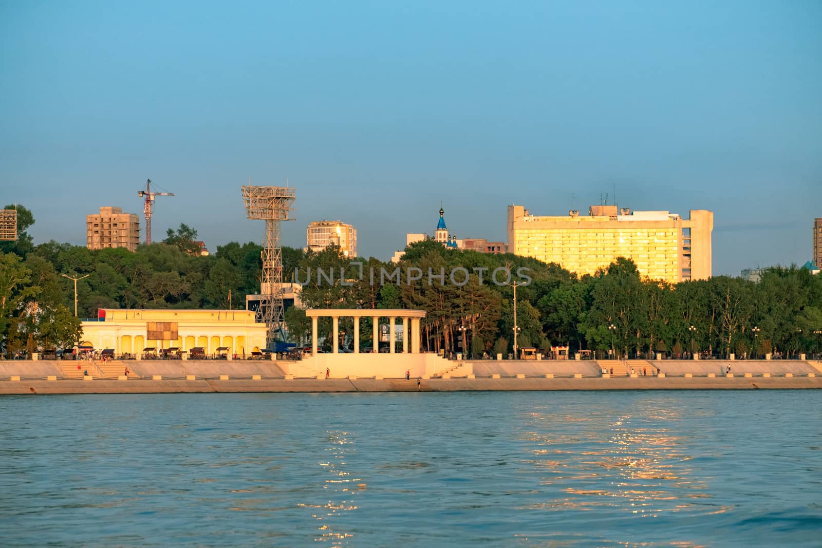 View of the city of Khabarovsk from the Amur river. Urban landscape in the evening at sunset