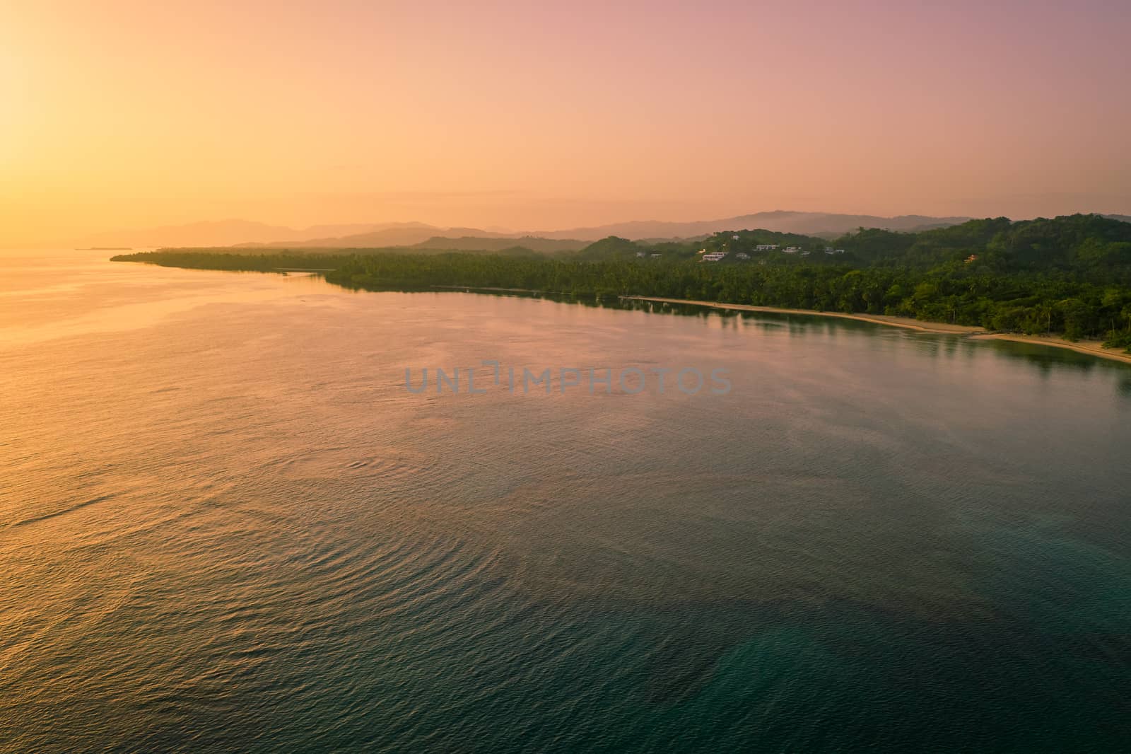 Drone shot of tropical beach at sunrise.Samana peninsula,Bahia Principe beach,Dominican Republic.