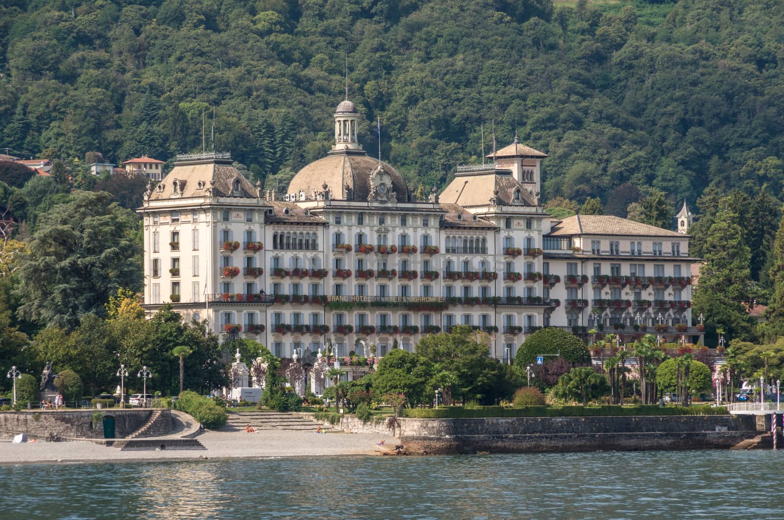 Stresa,Lake Maggiore,Italy-August 30,2018 : Grand Hotel Des Iles Borromees and Stresa town embankment, view from lake.