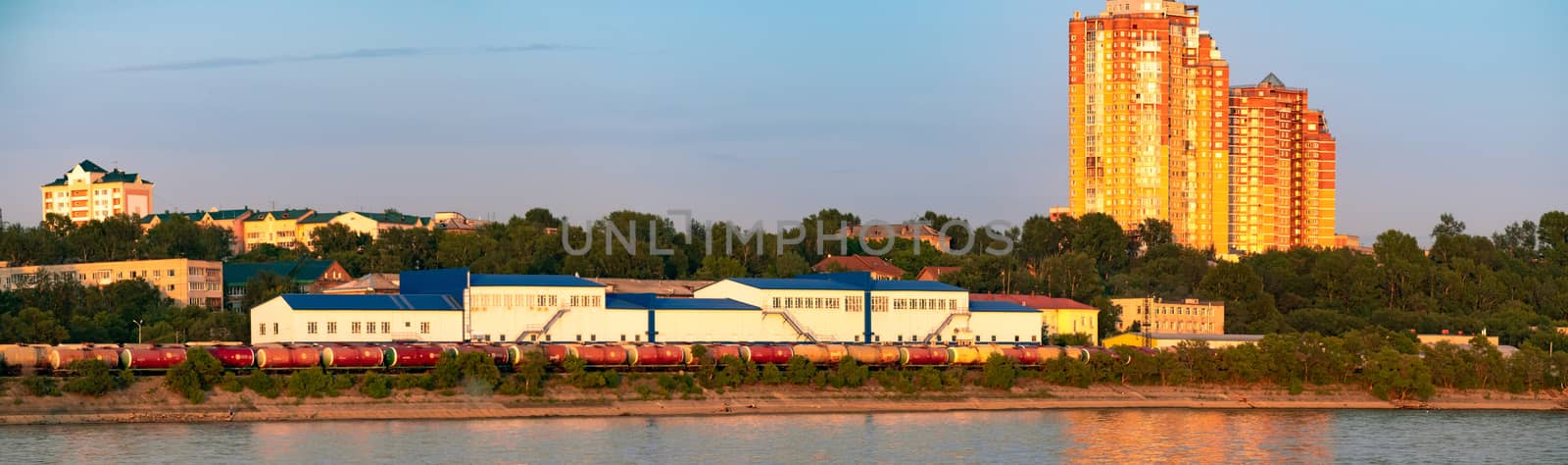 View of the city of Khabarovsk from the Amur river. Urban landscape in the evening at sunset