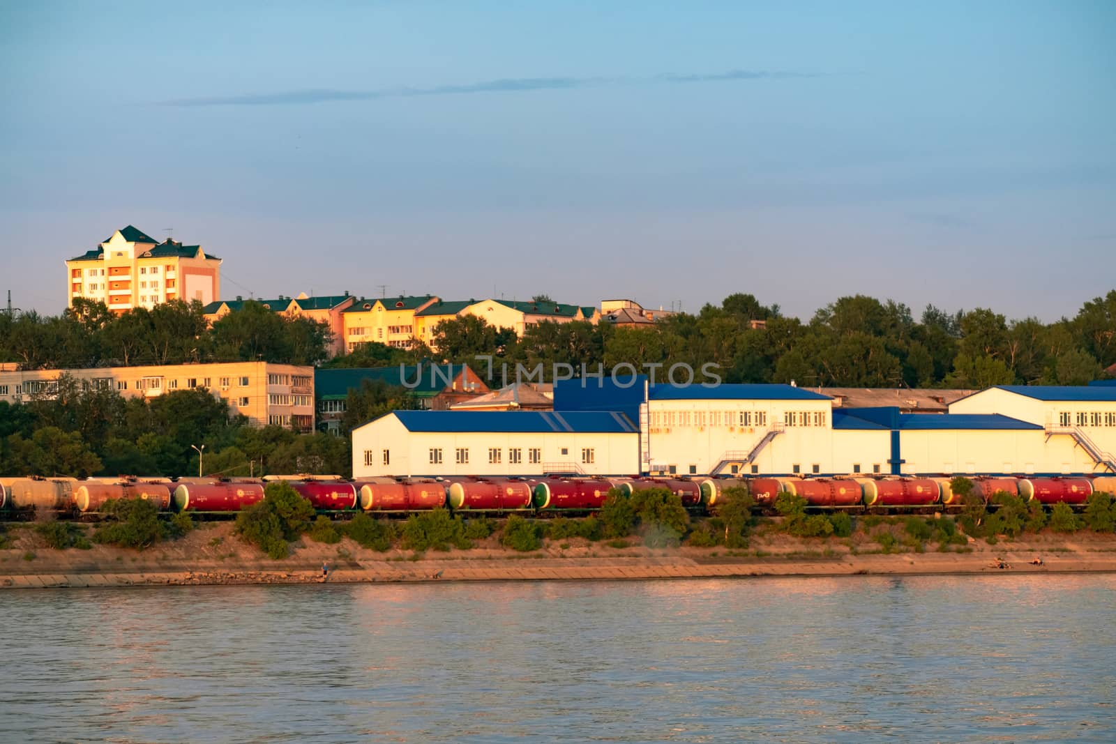 View of the city of Khabarovsk from the Amur river. Urban landscape in the evening at sunset