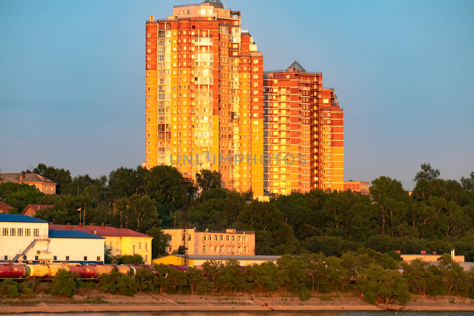 View of the city of Khabarovsk from the Amur river. Urban landscape in the evening at sunset