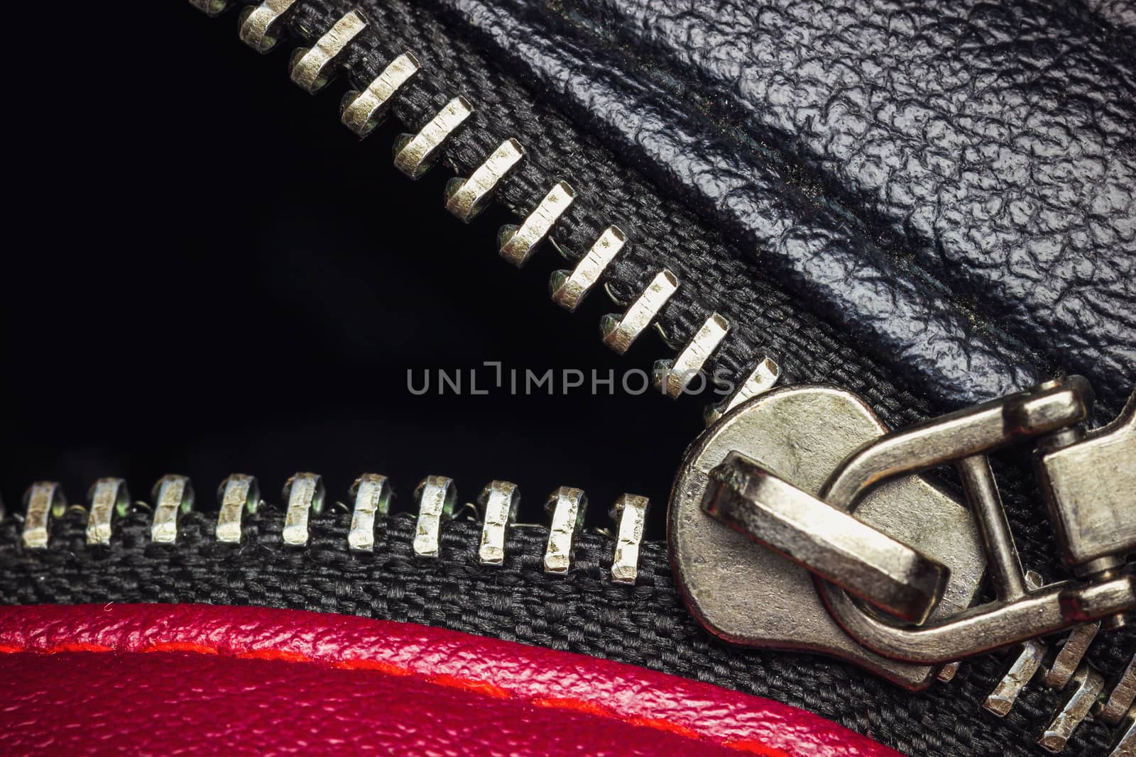 Close up stainless zipper in backpack leather. Concept of clothes or fashion.