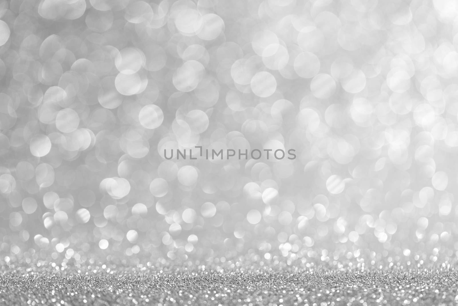 Abstract shining glitters silver holiday bokeh background with copy space for text