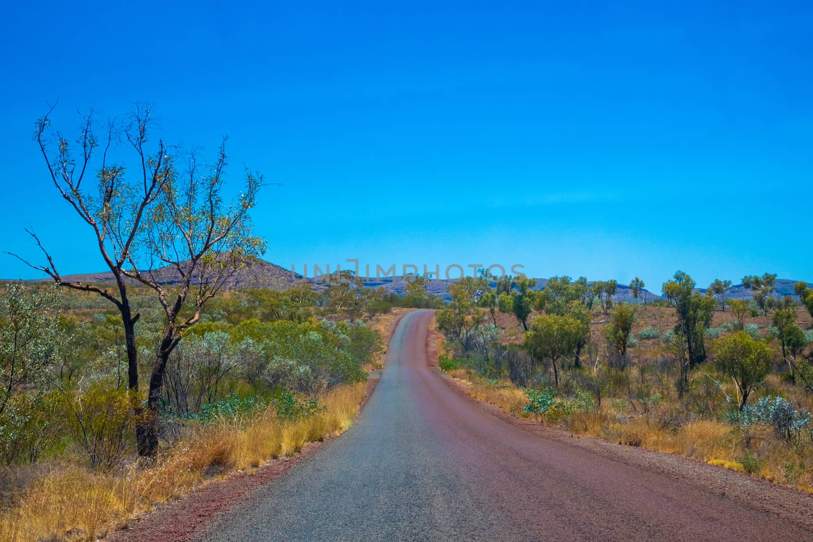 Half clean and half dusty road at Karijini National Park Australia