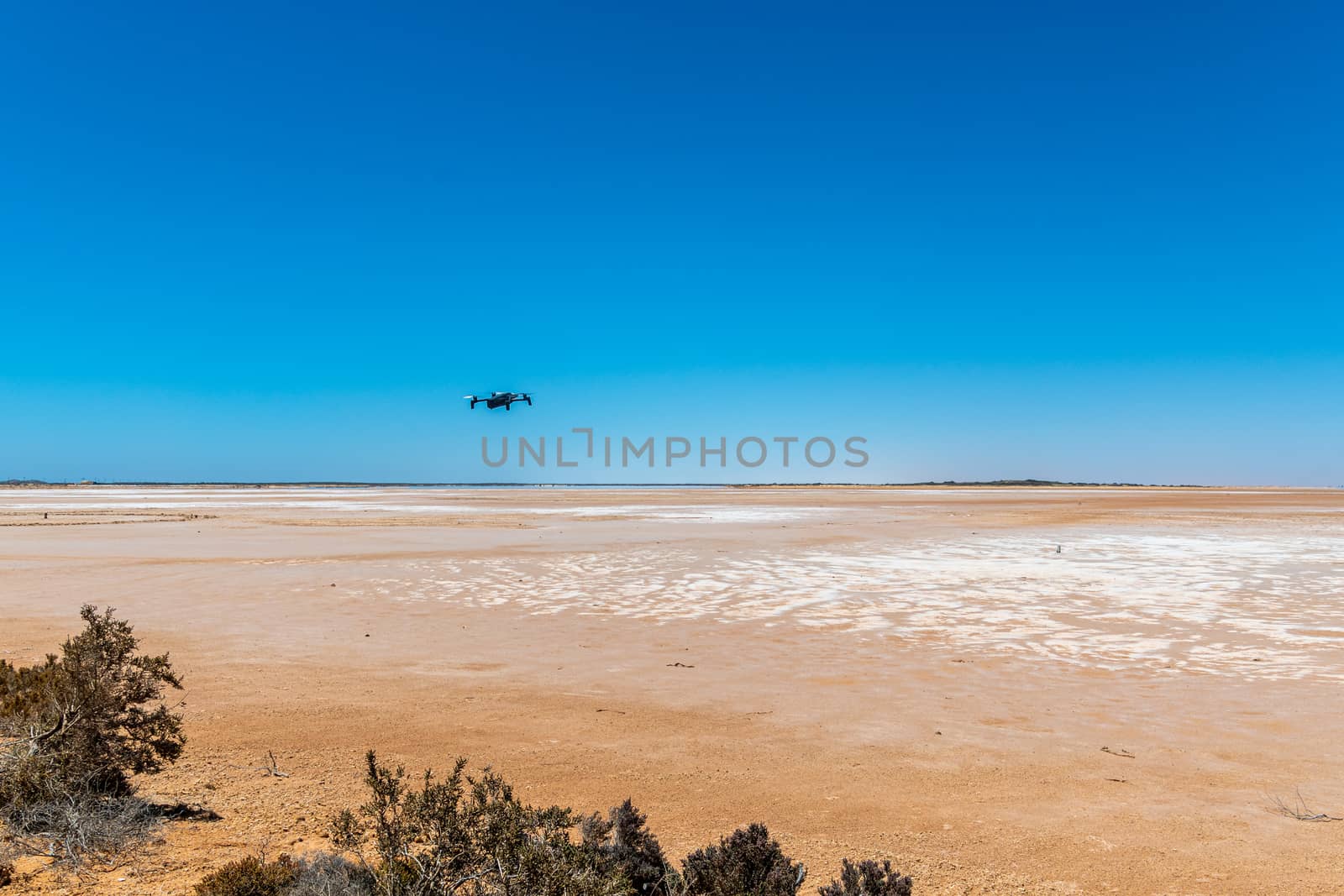 Lake Maclead drone hovering over arid salt lake in Western Australia mirage at horizon by MXW_Stock