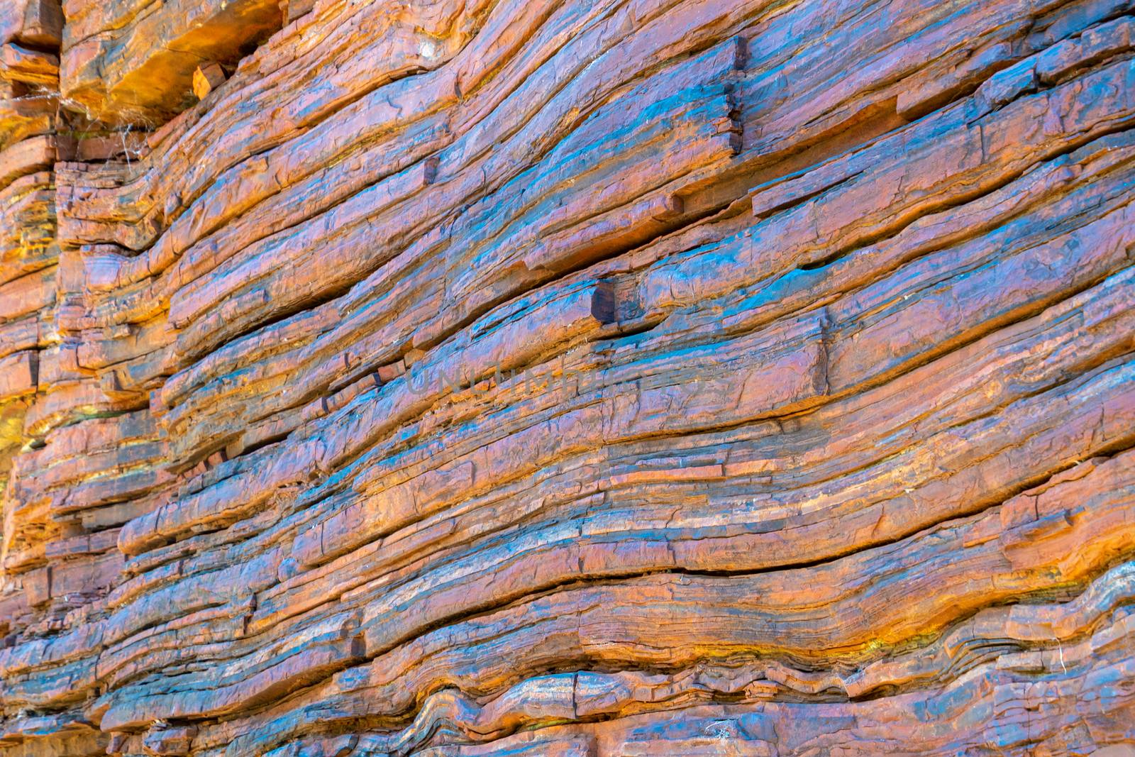 Layers of natural asbestos shining blue at Karijini National Park by MXW_Stock