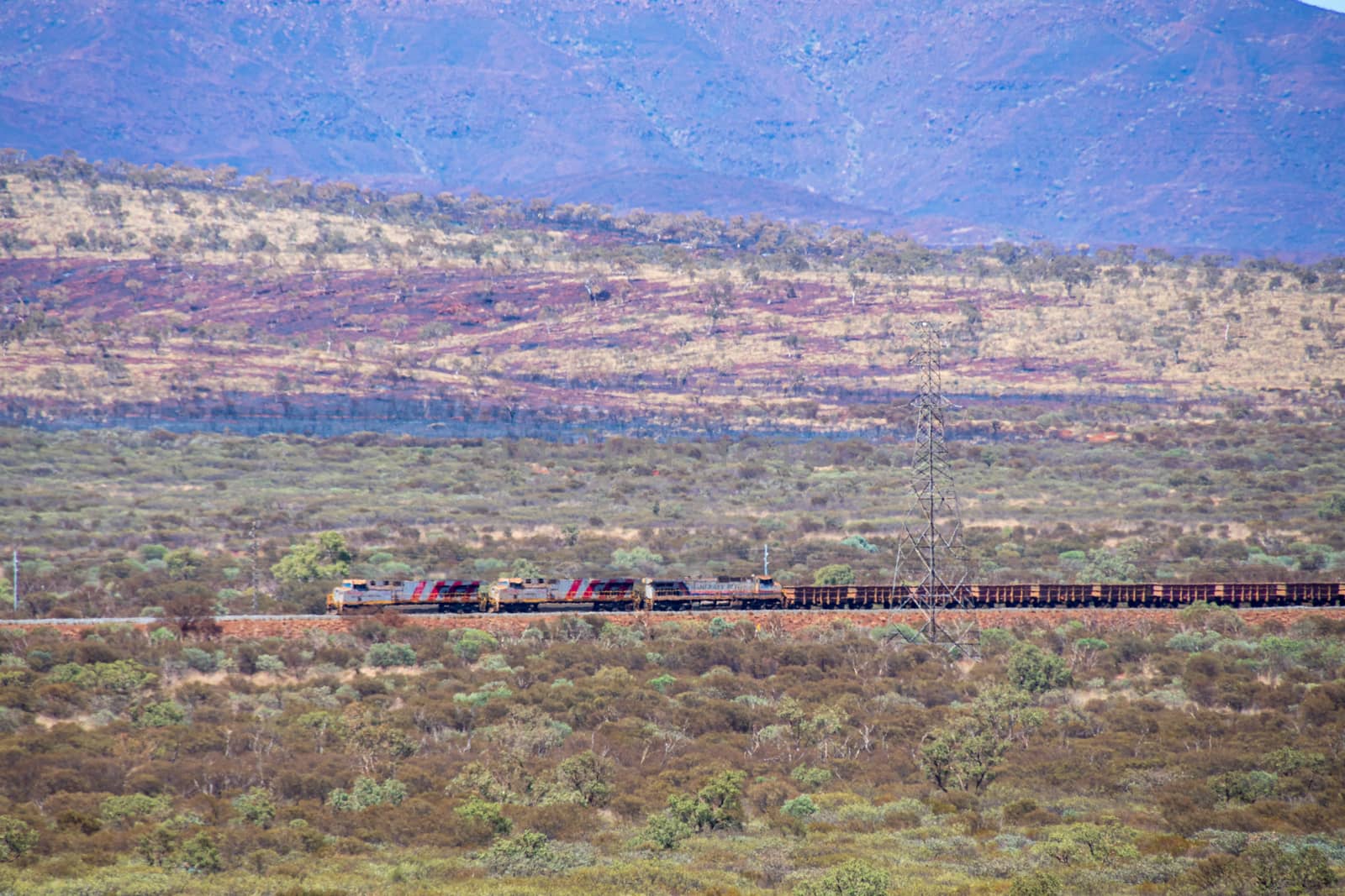 Long train at Karijini National Park transporting iron ore from Marandoo mine site towards next port