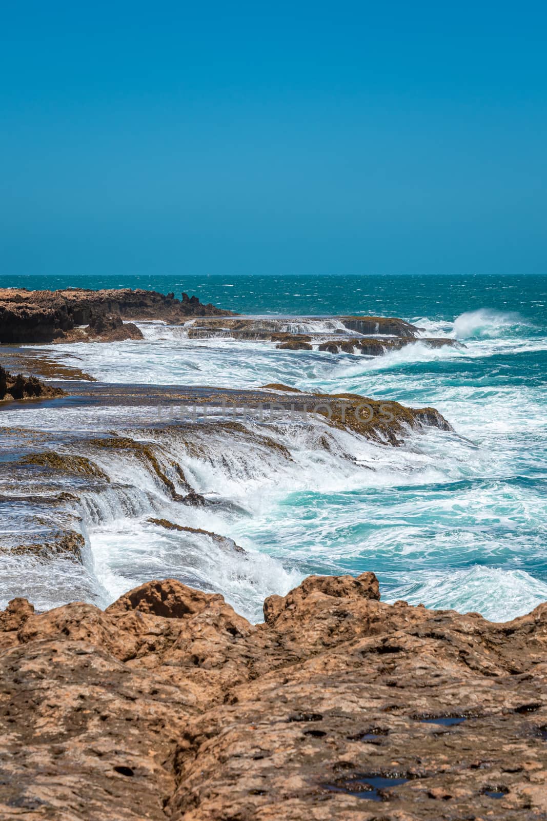 Quobba Blow Holes waves flooding coast during windy weather in Western Australia by MXW_Stock