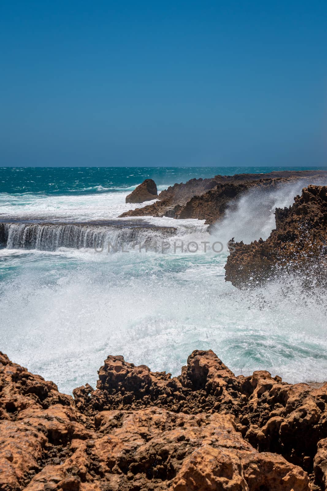 Quobba Blow Holes waves during windy weather in Western Australia by MXW_Stock