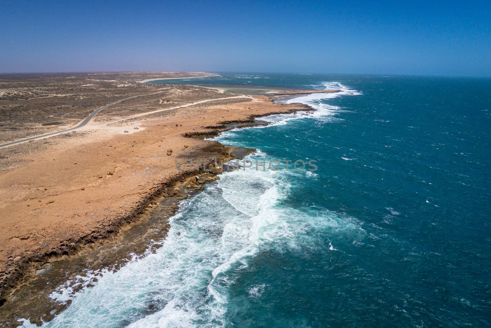 Quobba Blow Holes coast line aerial view of waves during windy weather in Western Australia by MXW_Stock