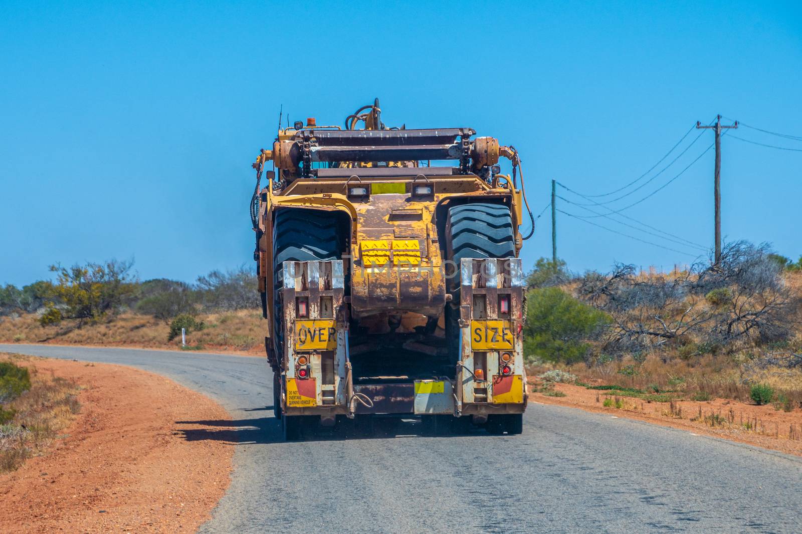 Road Train oversize load transport in Australia transporting big mining equipment by MXW_Stock
