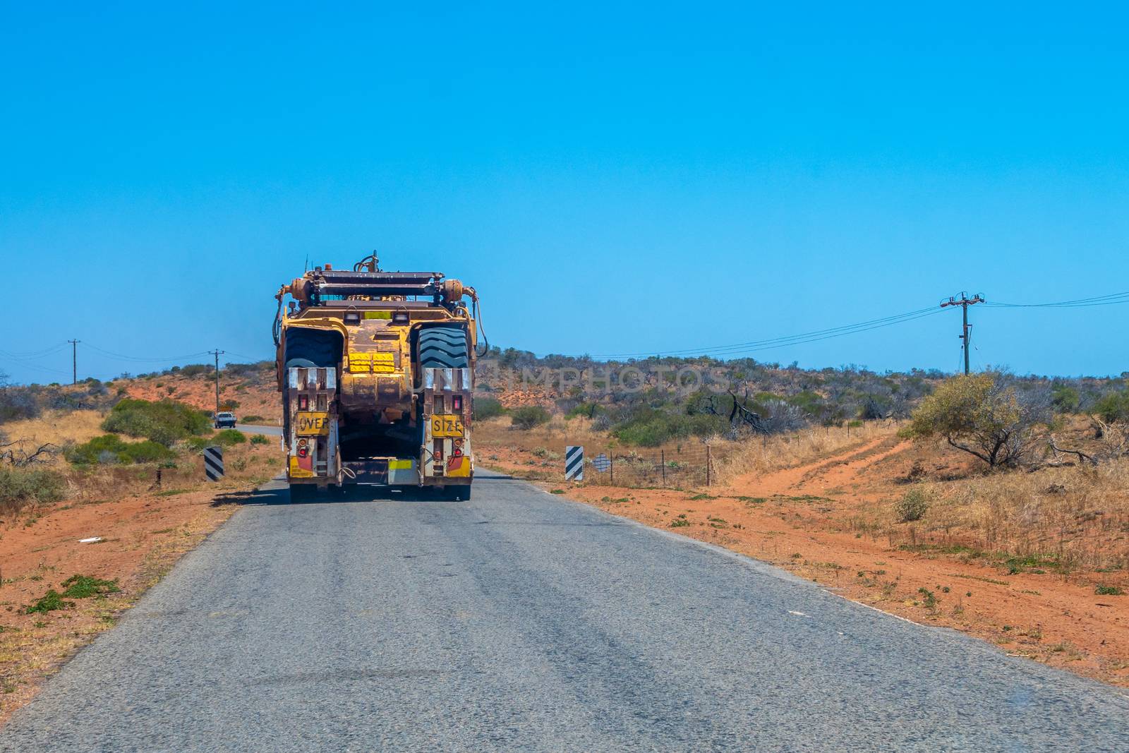 Road Train oversize transport in Australia transporting big mining equipment by MXW_Stock