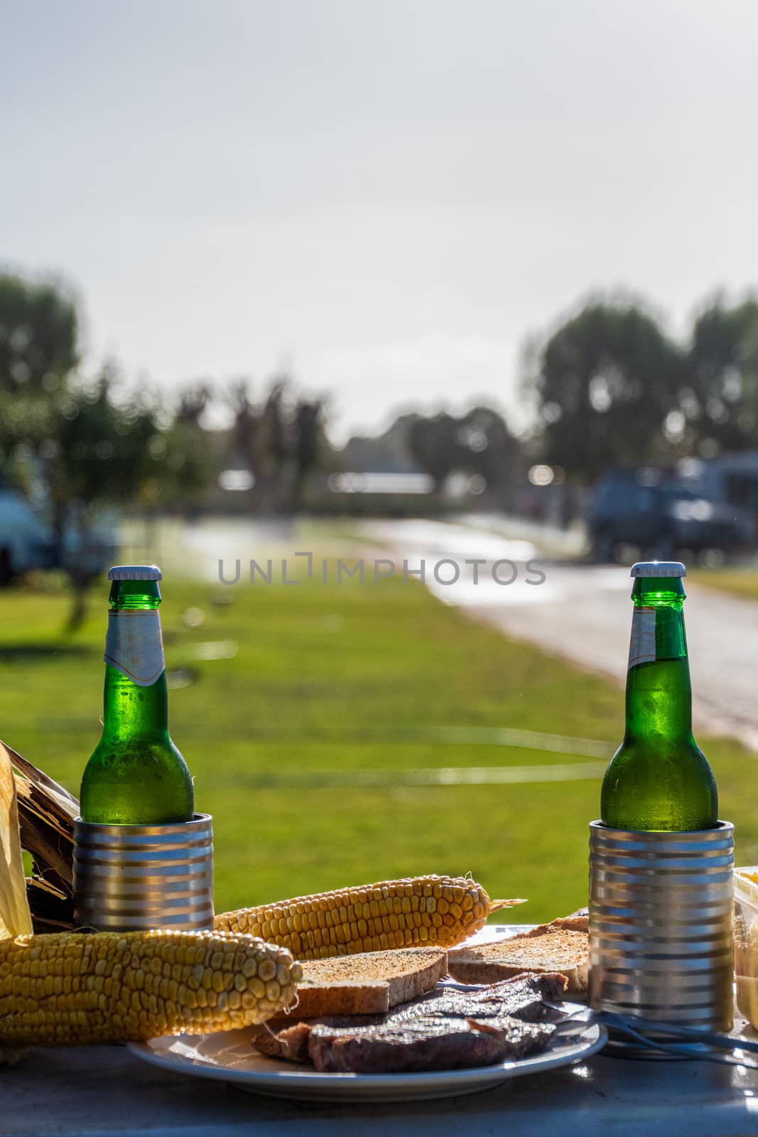 Steak beer toast and corn typical Australian camping food