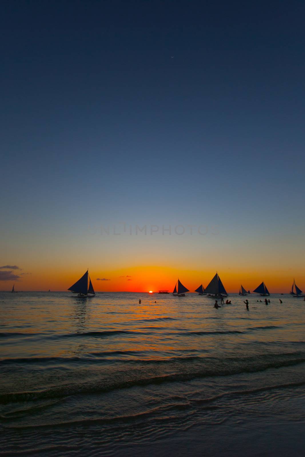 Beautiful sunset sky over the sea background and yachts at horizon