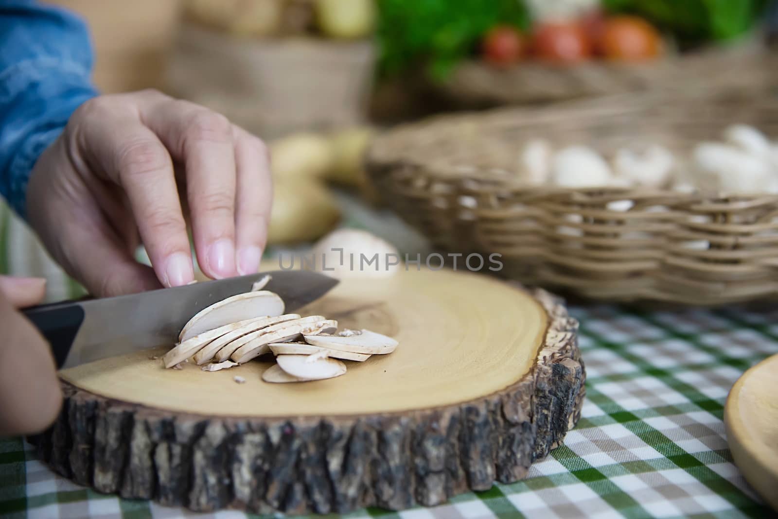 Lady cooks fresh champignon mushroom vegetable in the kitchen - people with vegetable cooking concept