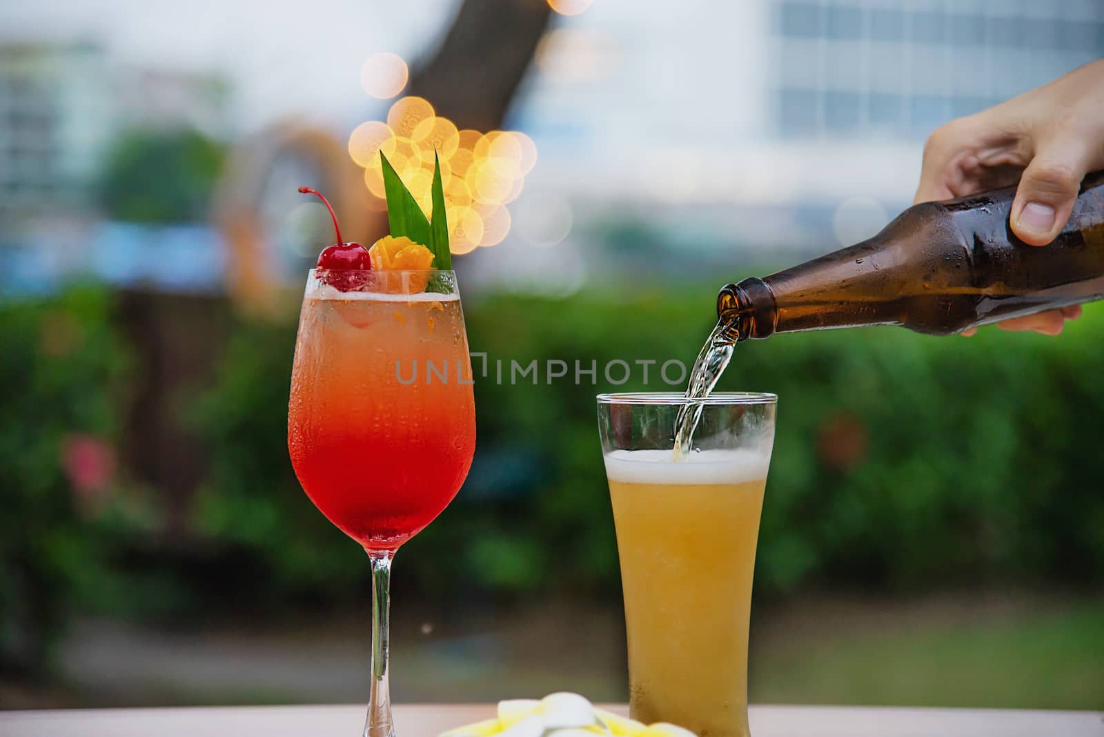 People celebration in restaurant with beer and mai tai or mai thai by pairhandmade