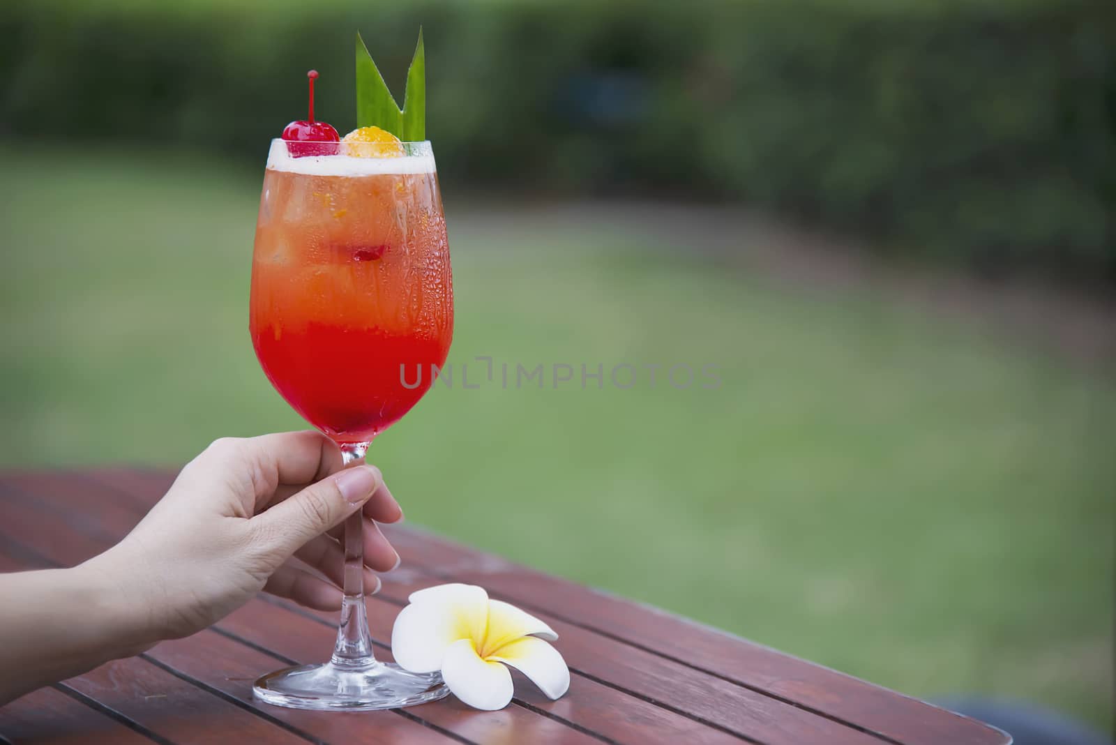Cocktail recipe name mai tai or mai thai worldwide favour cocktail include rum lime juice orgeat syrup and orange liqueur - sweet alcohol drink with flower in garden relax vacation concept