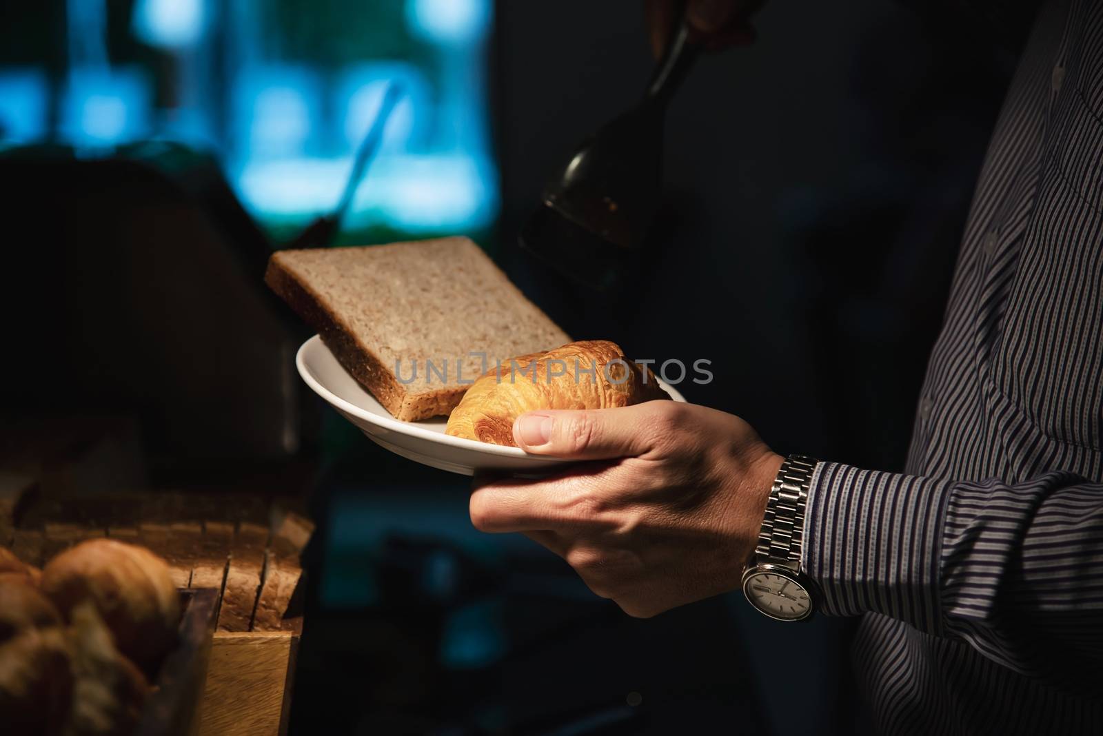 Business man eat the American breakfast set in a hotel by pairhandmade