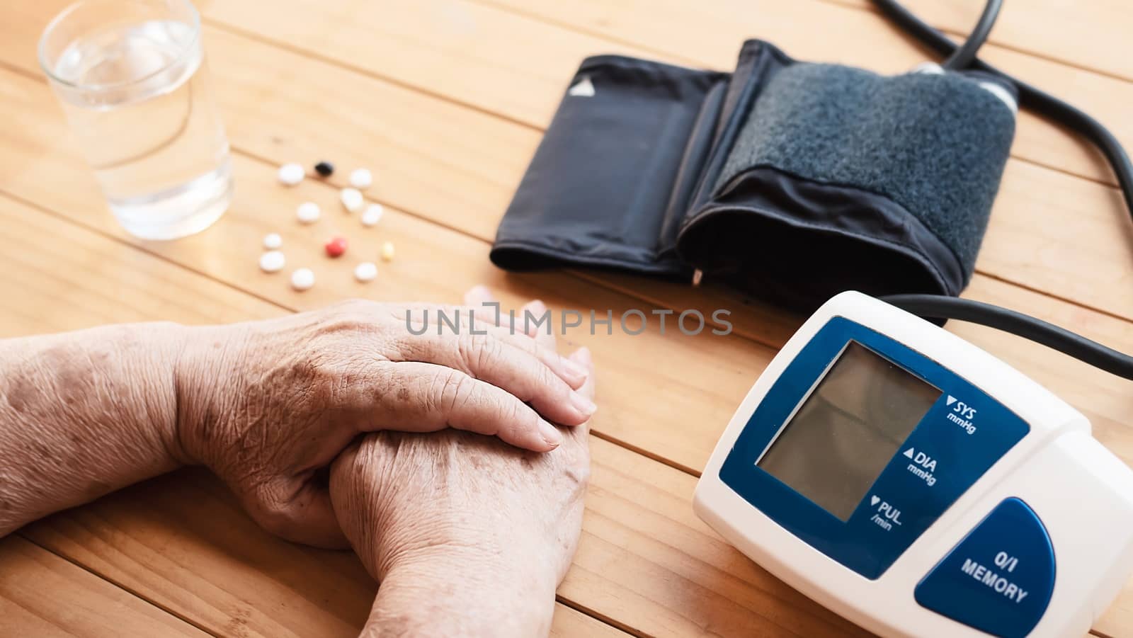 Old lady is being checked blood pressure using blood pressure monitor kid set by pairhandmade