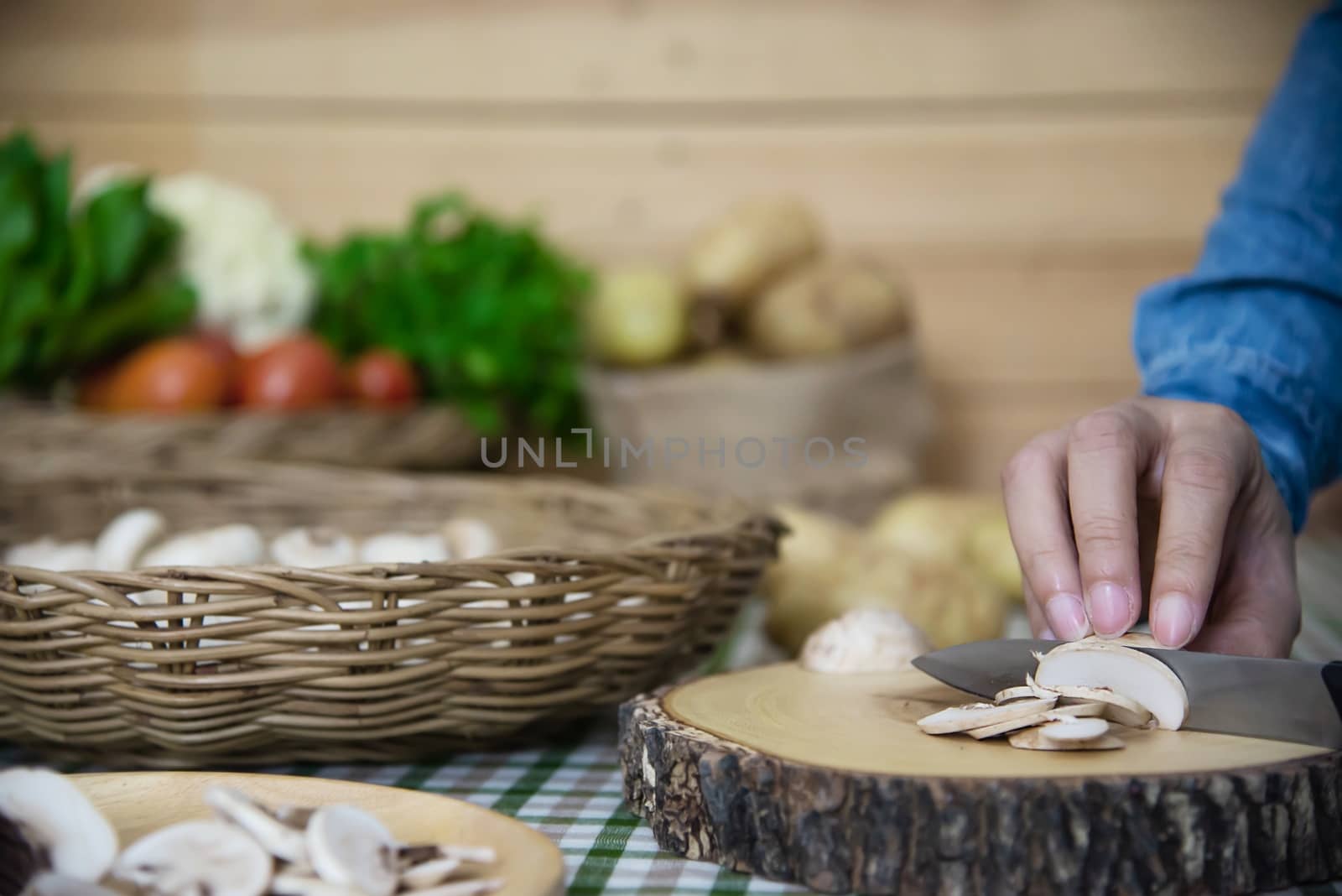 Lady cooks fresh champignon mushroom vegetable in the kitchen - people with vegetable cooking concept