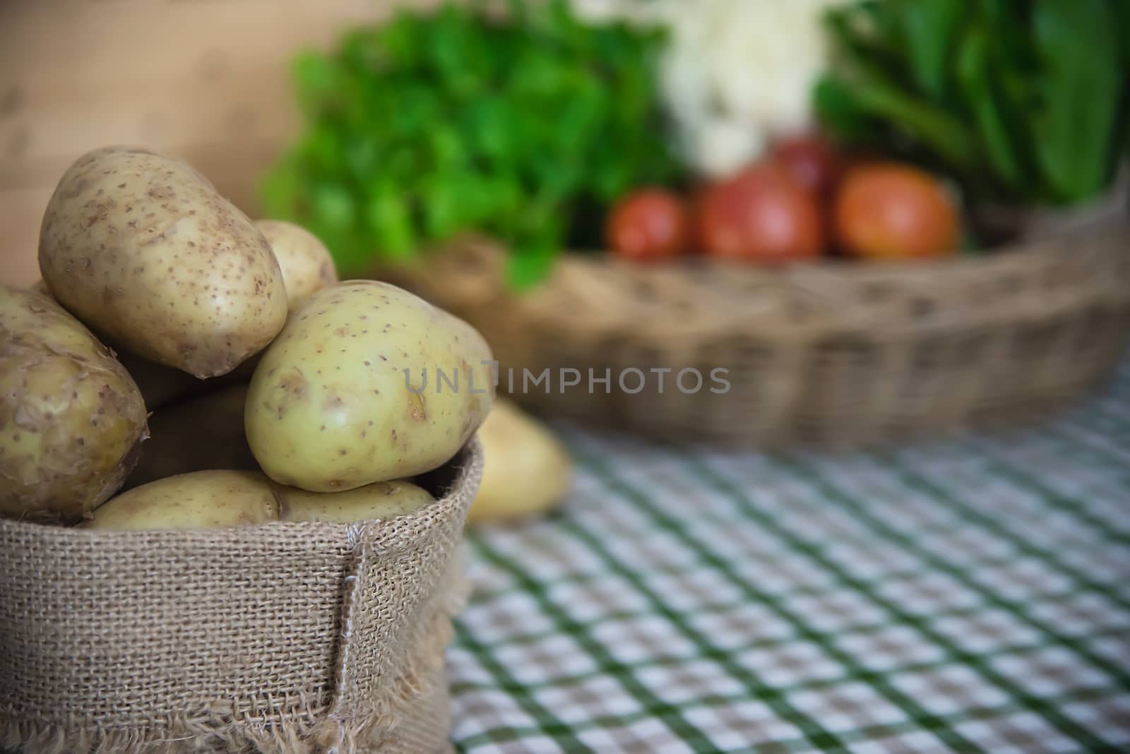 Fresh potato ready for cooking with potato sack background by pairhandmade